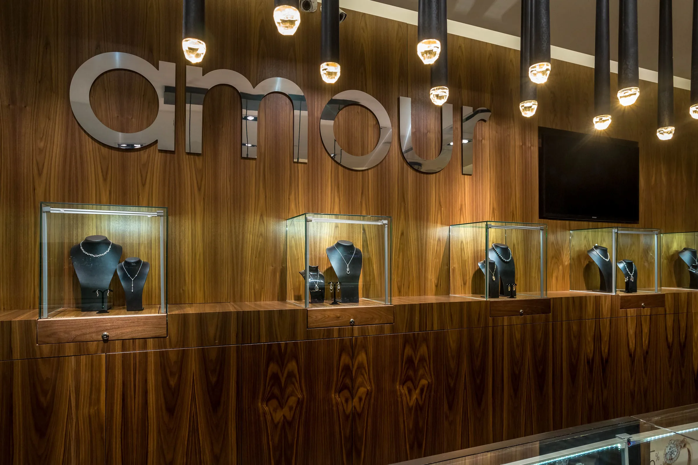 Amour Jewellers — custom display wall and pendant lighting by Shantam Interiors