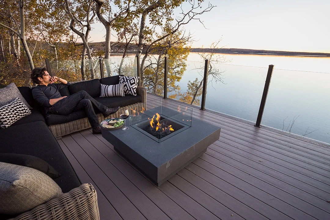 A quiet evening on the deck of the Lake House, fire lit, water still